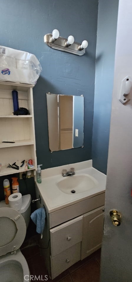 bathroom with vanity, tile patterned floors, and toilet