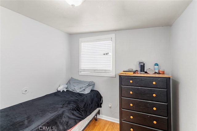 bedroom featuring light wood-type flooring and baseboards