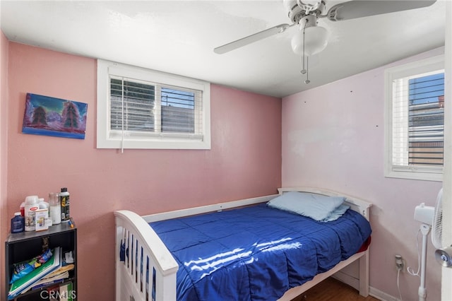 bedroom featuring baseboards and ceiling fan