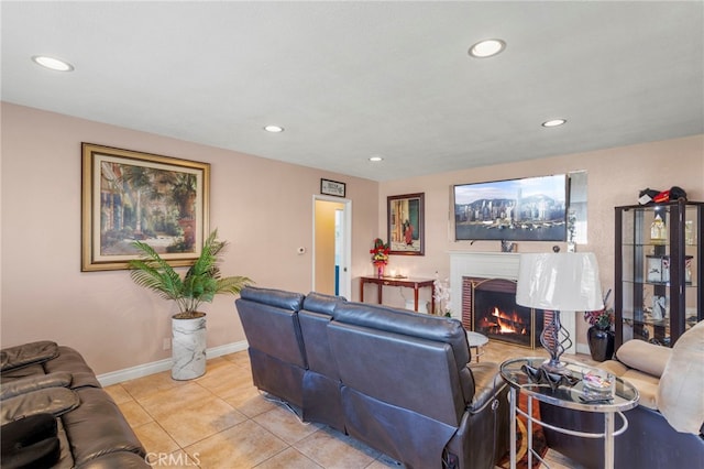 tiled living room featuring a brick fireplace