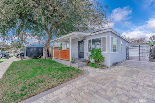 bungalow-style house featuring a front yard