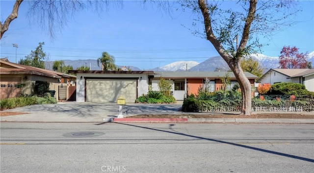 ranch-style house with a mountain view and a garage