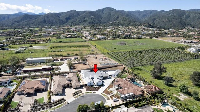 birds eye view of property with a mountain view
