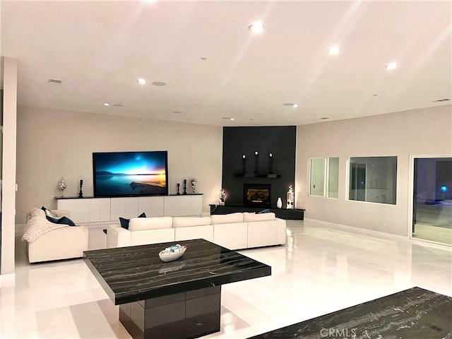 living room featuring recessed lighting, visible vents, and a fireplace