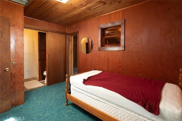 bedroom featuring wooden ceiling, a closet, carpet flooring, and wood walls