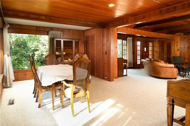 dining area with a healthy amount of sunlight and wooden walls