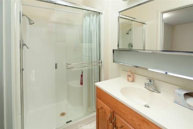 full bath with a stall shower and vanity