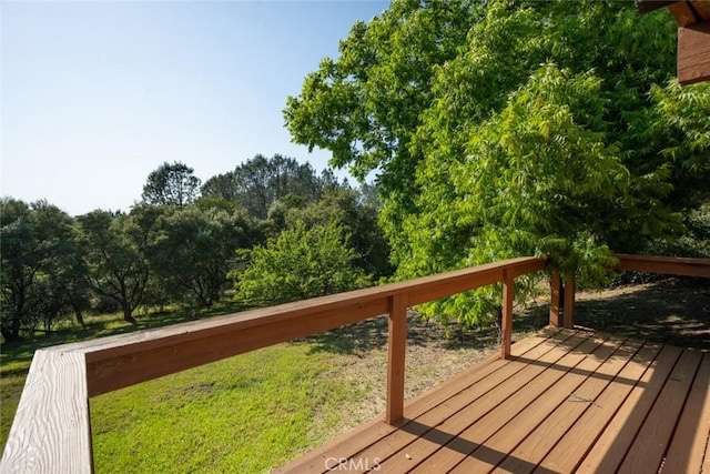 wooden deck with a lawn