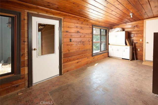 unfurnished room with wood walls and wooden ceiling