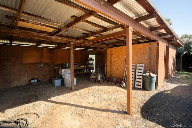 view of side of home with an exterior structure, metal roof, a carport, and an outbuilding