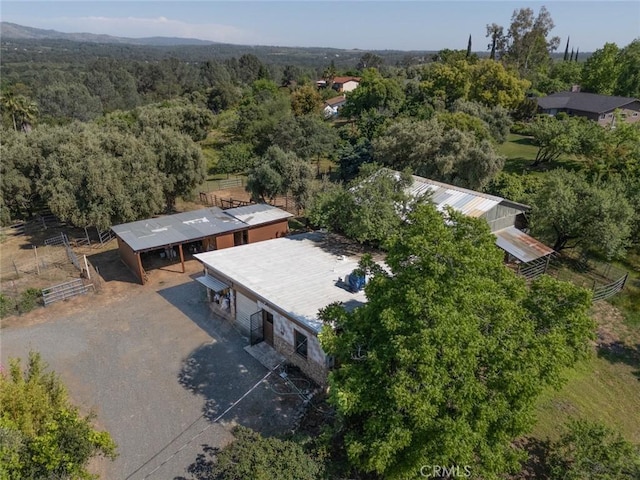 birds eye view of property featuring a wooded view