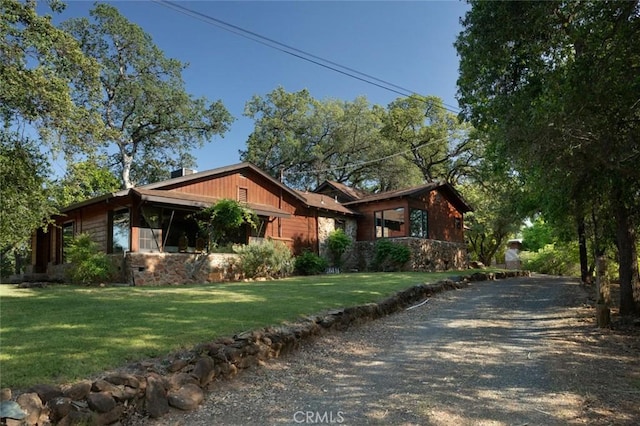 view of home's exterior with driveway and a yard