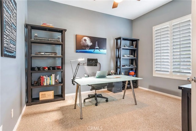 office area featuring ceiling fan, carpet, and baseboards