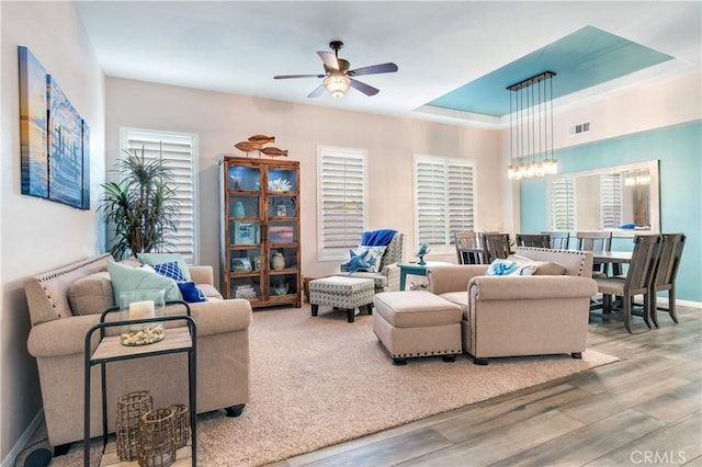 living room featuring light wood-style floors, a wealth of natural light, and visible vents