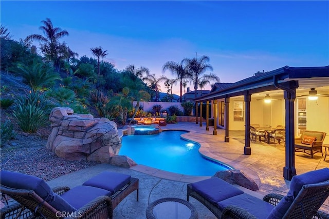 view of pool with a pool with connected hot tub, a fenced backyard, and a patio