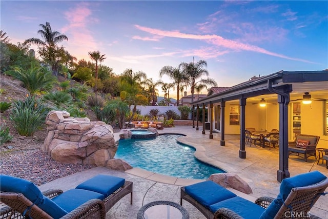 view of swimming pool featuring a fenced in pool, a ceiling fan, a patio area, fence, and an in ground hot tub