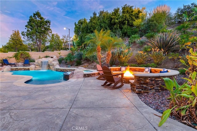 view of pool featuring a patio, an outdoor fire pit, fence, and a fenced in pool