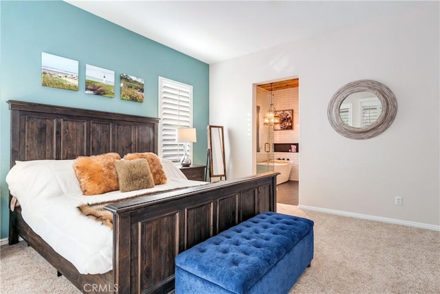 bedroom featuring light colored carpet, connected bathroom, and baseboards