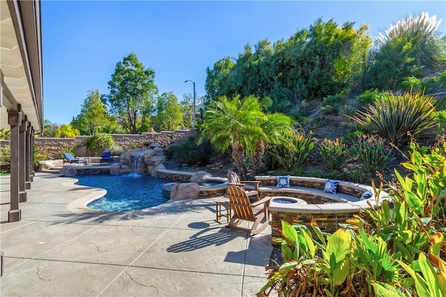 view of pool with a patio, an outdoor fire pit, and a jacuzzi