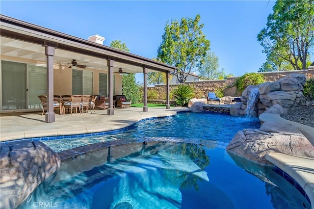 view of pool with a patio, a pool with connected hot tub, outdoor dining space, ceiling fan, and a fenced backyard