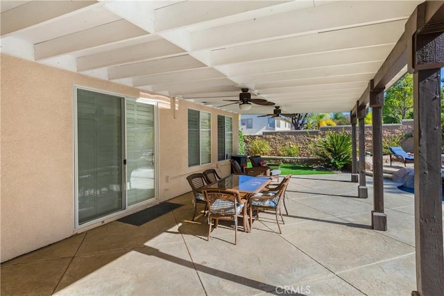 view of patio / terrace featuring ceiling fan, outdoor dining area, and fence