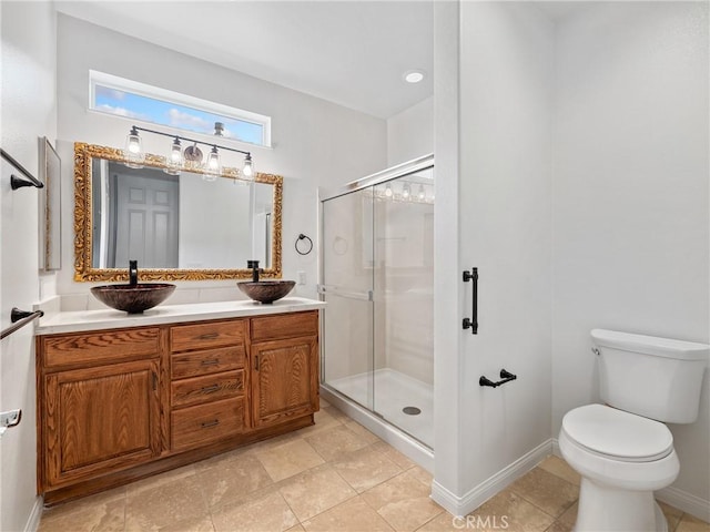 bathroom with an enclosed shower, vanity, and toilet