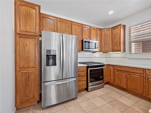 11175 Avonlea Rd, Apple Valley, CA 92308 - kitchen with stainless steel appliances, brown cabinetry, and light countertops