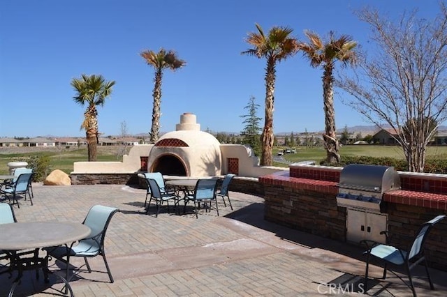 11175 Avonlea Rd, Apple Valley, CA 92308 - view of patio with an outdoor fireplace, area for grilling, and outdoor dining area