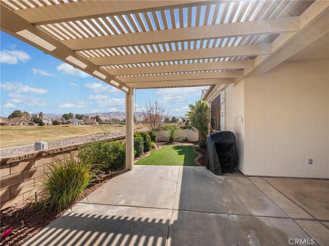 view of patio with grilling area and a pergola