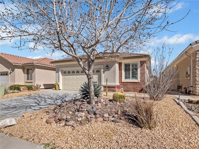 11175 Avonlea Rd, Apple Valley, CA 92308 - single story home with driveway, a garage, brick siding, and stucco siding