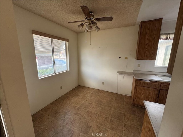 kitchen featuring ceiling fan and a textured ceiling