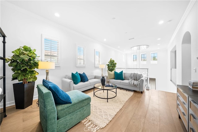 living room with light hardwood / wood-style floors and crown molding