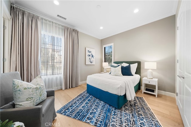 bedroom featuring ornamental molding and hardwood / wood-style floors