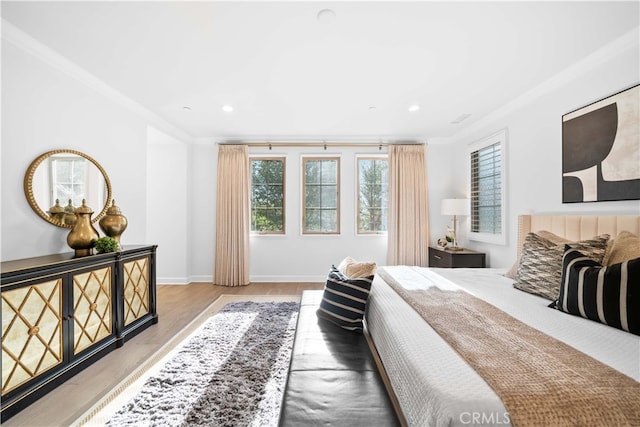 bedroom featuring ornamental molding and hardwood / wood-style floors