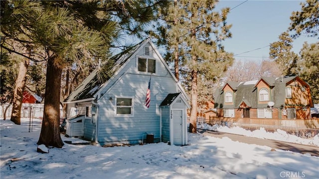 view of snow covered back of property