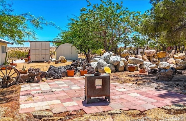 view of patio / terrace featuring a storage unit