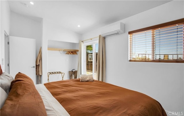 bedroom featuring a wall mounted air conditioner, vaulted ceiling, and access to outside