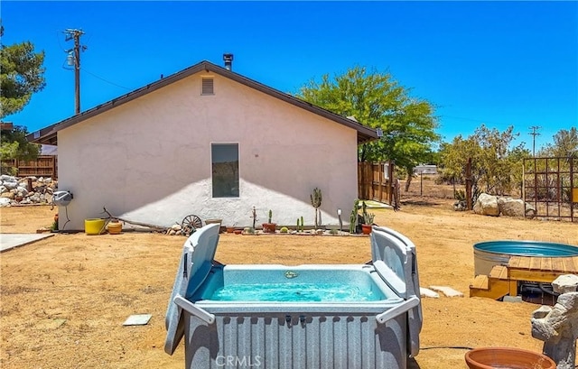 exterior space with a hot tub