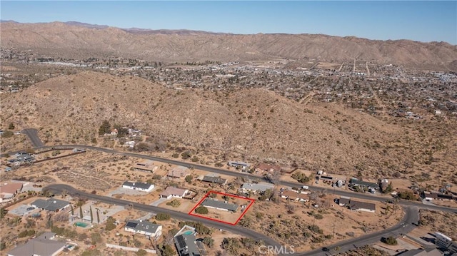 birds eye view of property with a mountain view