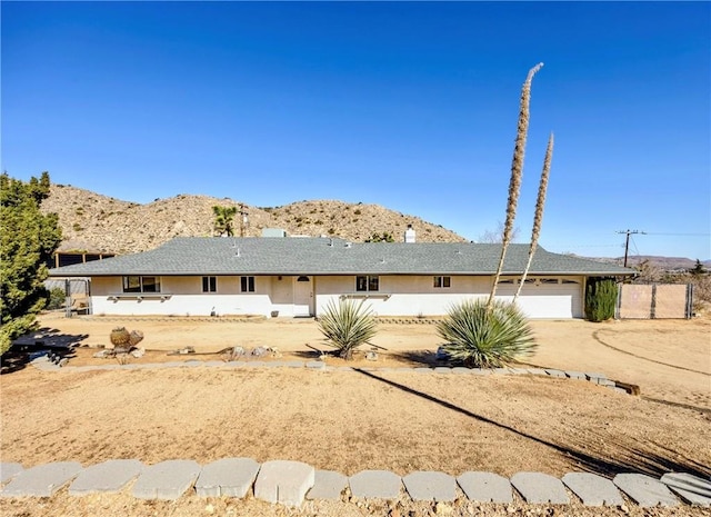 single story home with a mountain view and a garage