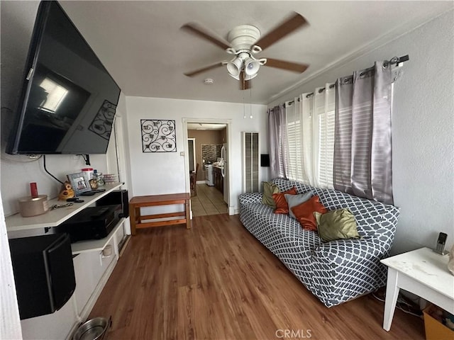 living room featuring hardwood / wood-style floors and ceiling fan