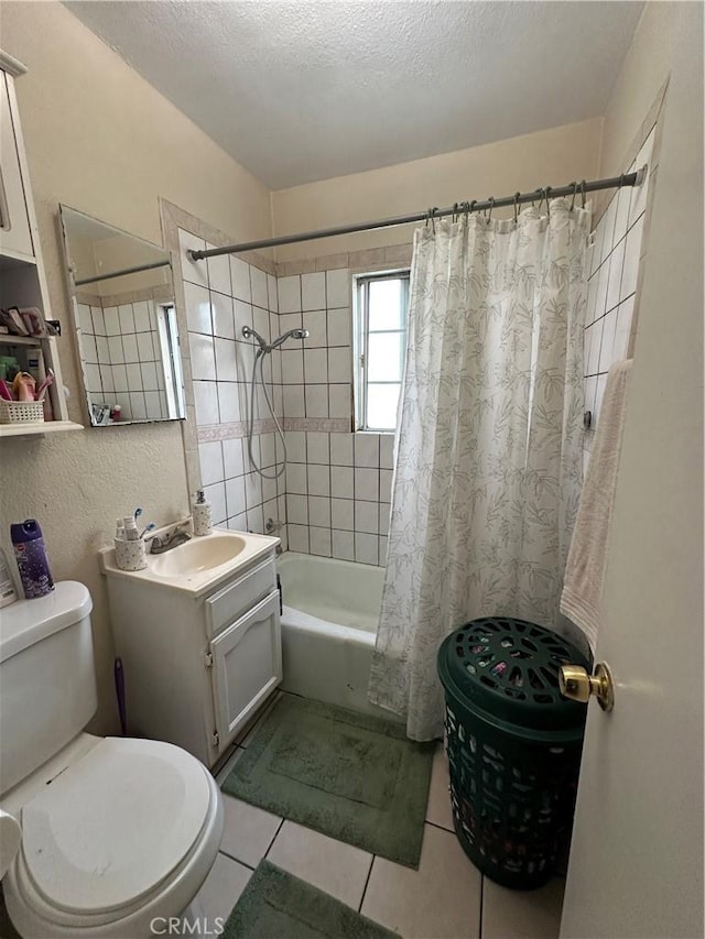 full bathroom with tile patterned flooring, vanity, shower / bath combo, and a textured ceiling