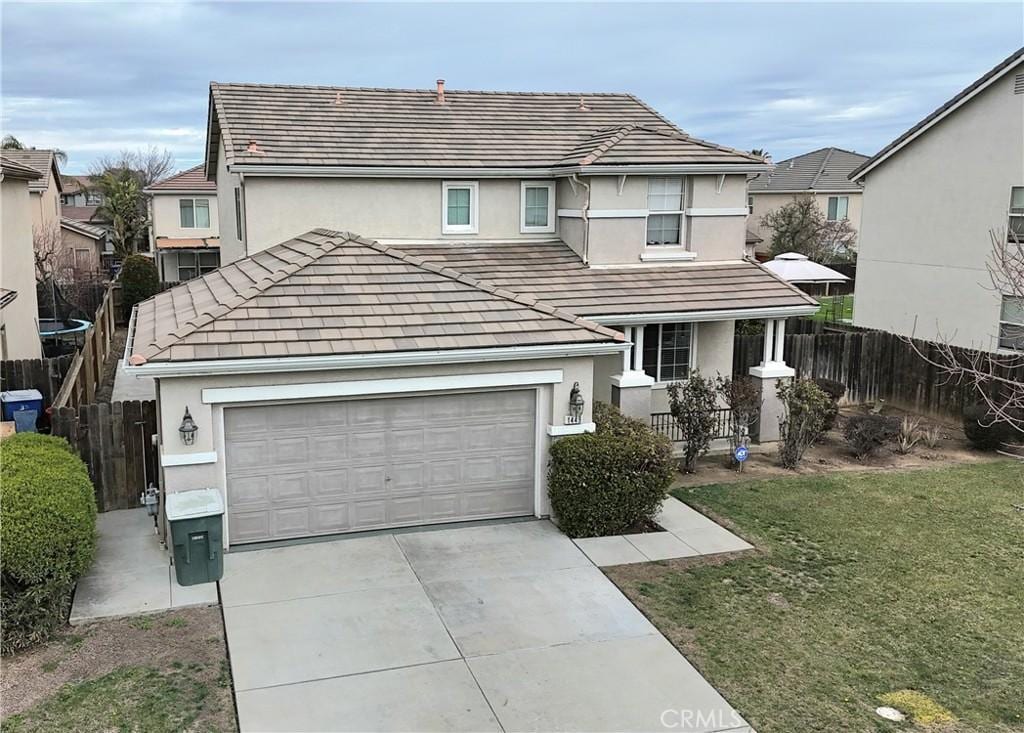 view of front property with a garage and a front lawn