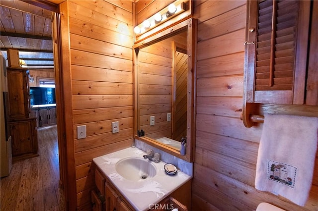 1971 Fern Ln, Big Bear City, CA 92314 - bathroom featuring vanity, hardwood / wood-style floors, and wooden walls