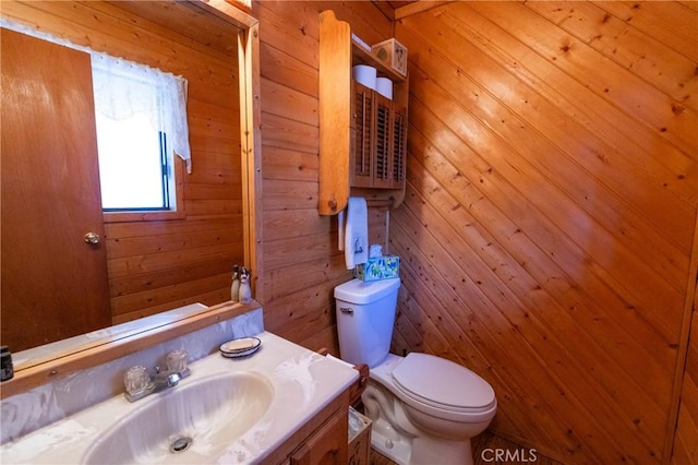 1971 Fern Ln, Big Bear City, CA 92314 - bathroom with vanity, wooden walls, and toilet