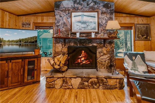 1971 Fern Ln, Big Bear City, CA 92314 - living room with lofted ceiling, wood ceiling, a stone fireplace, and wood walls