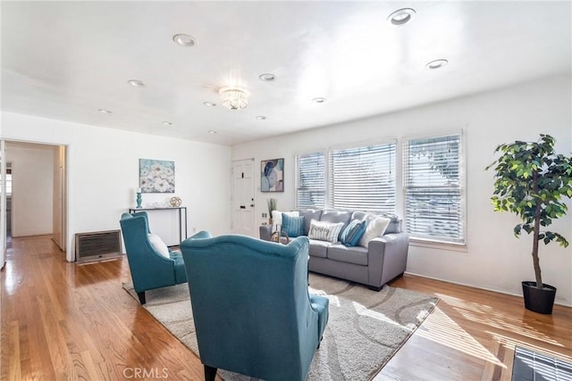 living room featuring recessed lighting, visible vents, and light wood-style floors