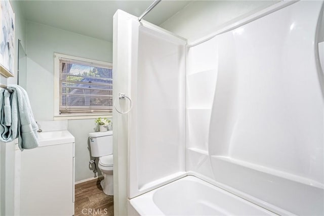 bathroom with vanity, shower / tub combination, wood finished floors, and toilet