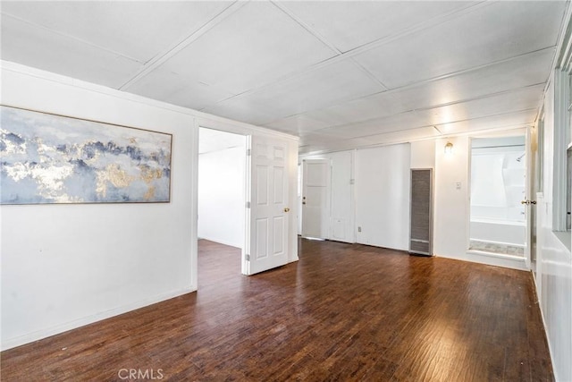 empty room featuring wood finished floors and visible vents