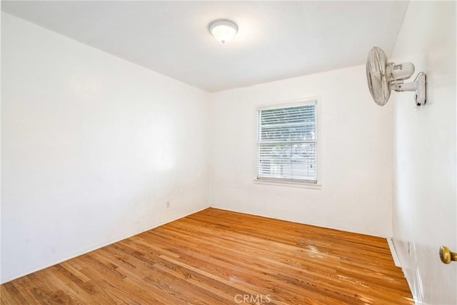 spare room with wood finished floors